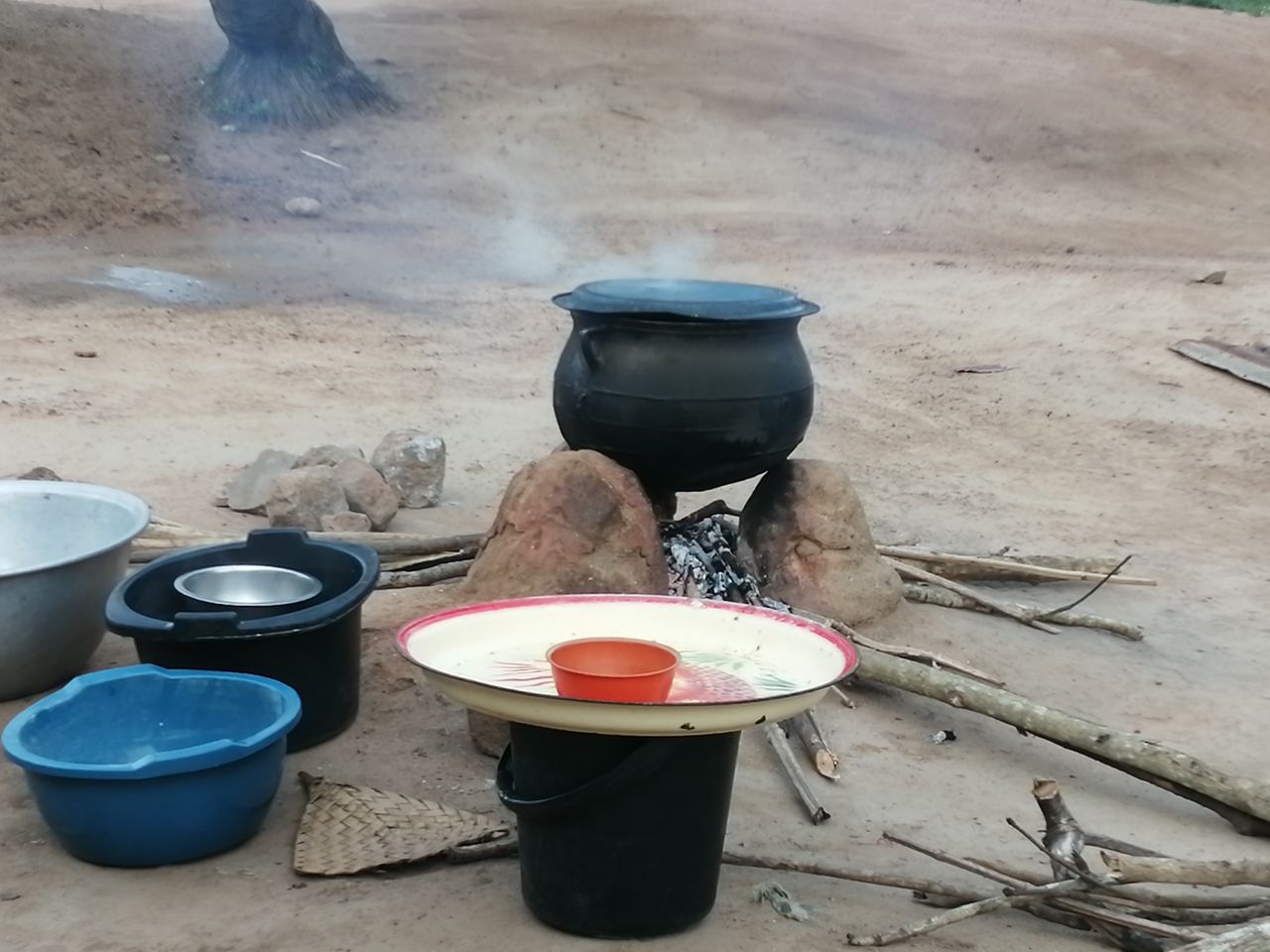 employée de maison Togo préparant un repas sur un foyer traditionnel