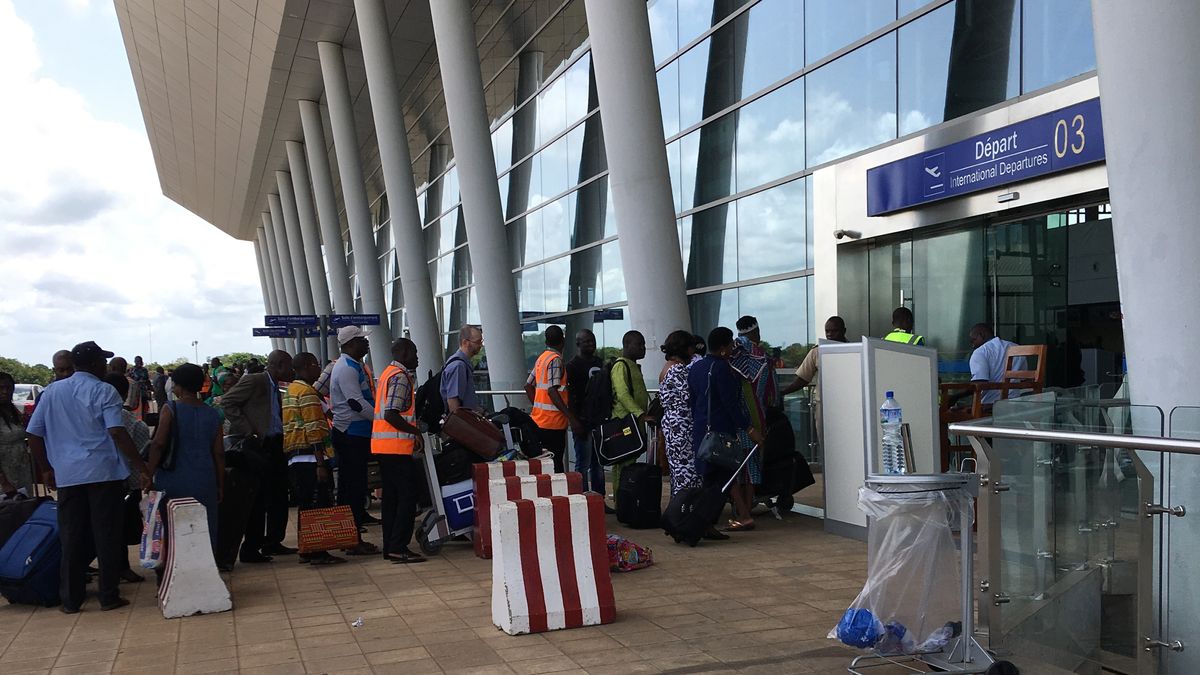 Passeport togolais : voyageurs devant l'entrée des départs internationaux de l'aéroport de Lomé