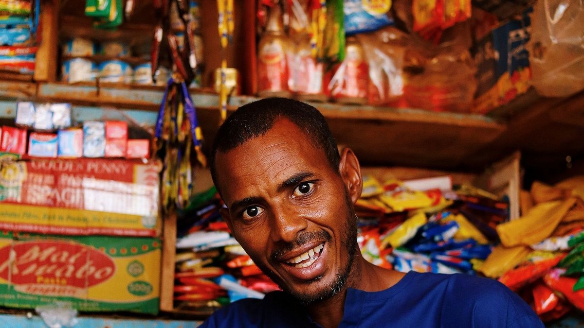 Fonds de commerce au Togo - épicier africain devant les rayons de son commerce